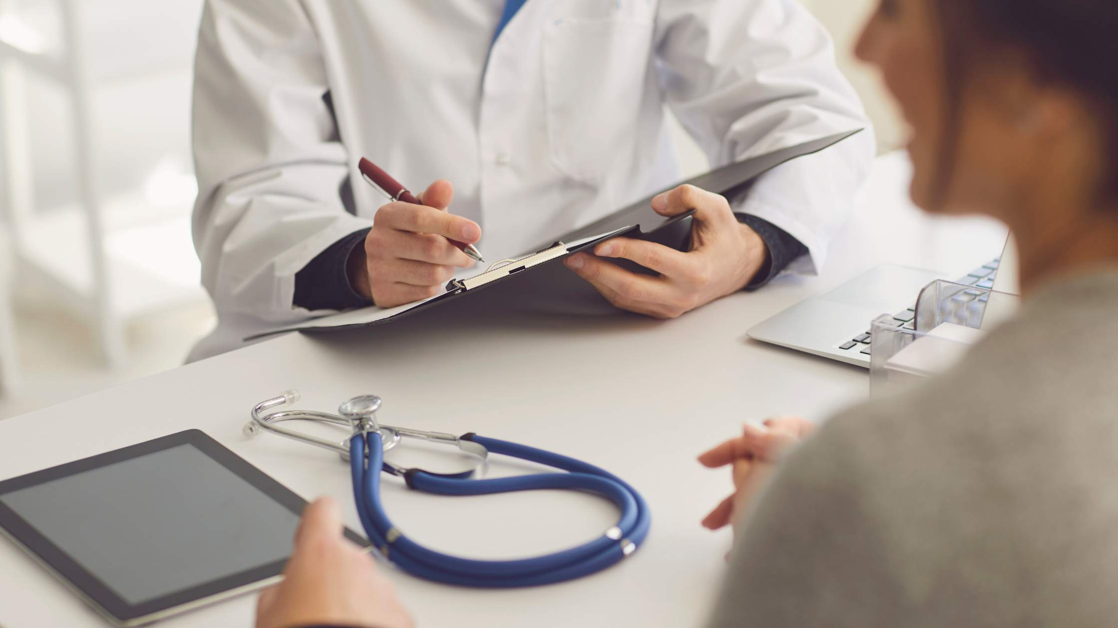 An image of a medical professional talking with a patient.