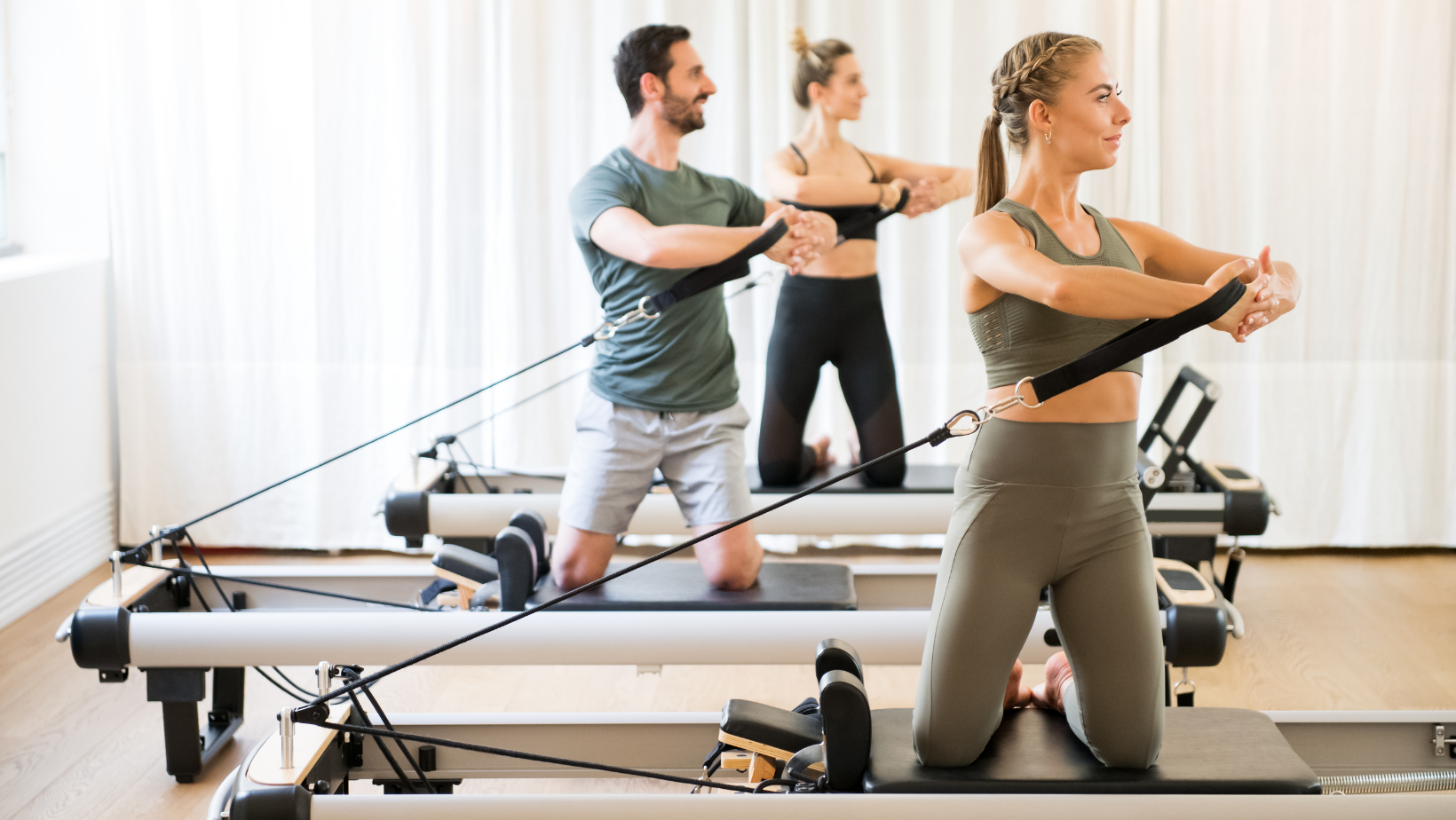 A group of pilates instructors teaching a class
