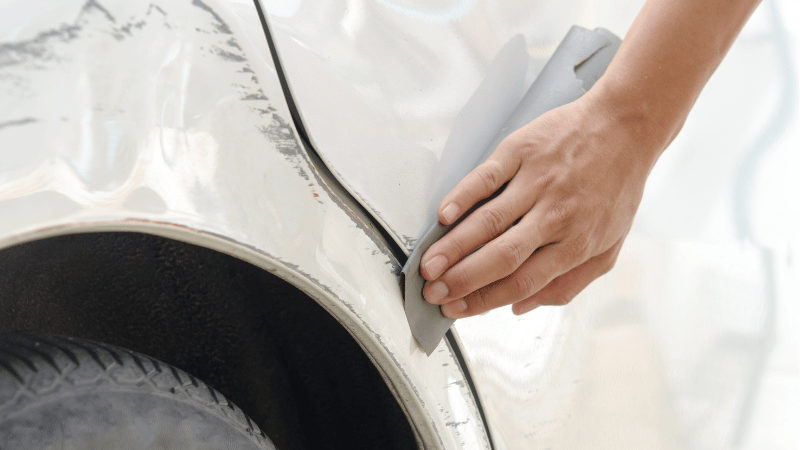 A man is getting the minor abrasions and scratches repaired.