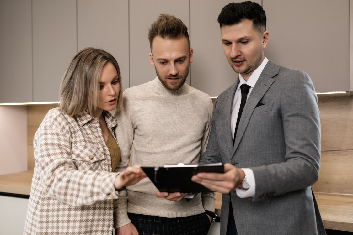 Couple consulting with business broker about buyer screening and due diligence process