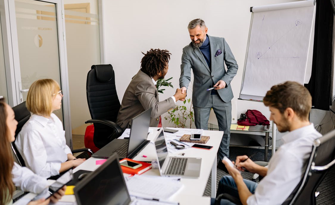 People Shaking Hands in Corporate Meeting Development