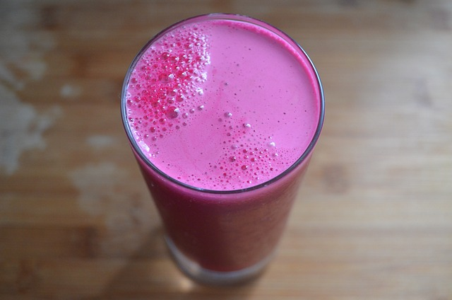 a glass of beet juice on table, top view