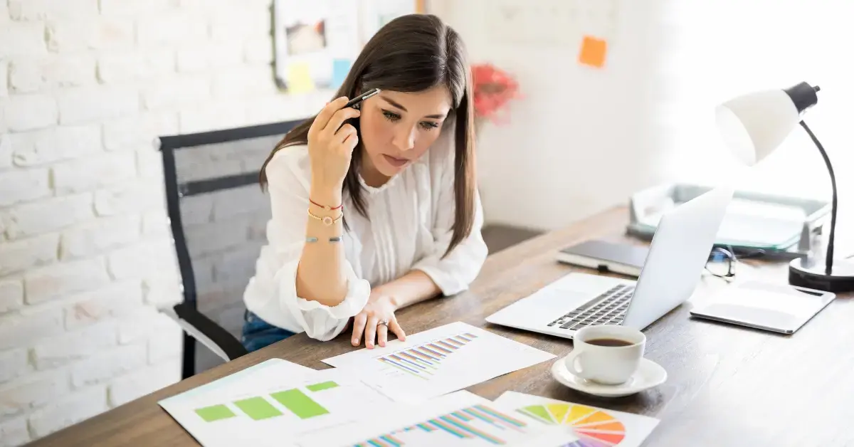 Woman reviewing business records and Form 433-B for an IRS tax debt case.