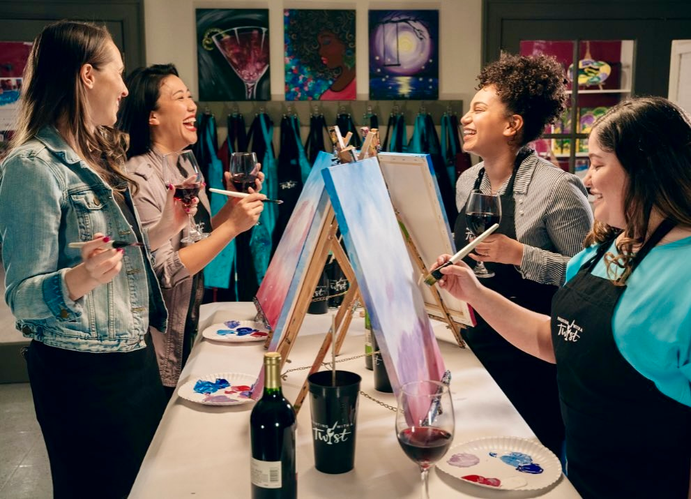 A group of women participating in a Painting with a Twist class 