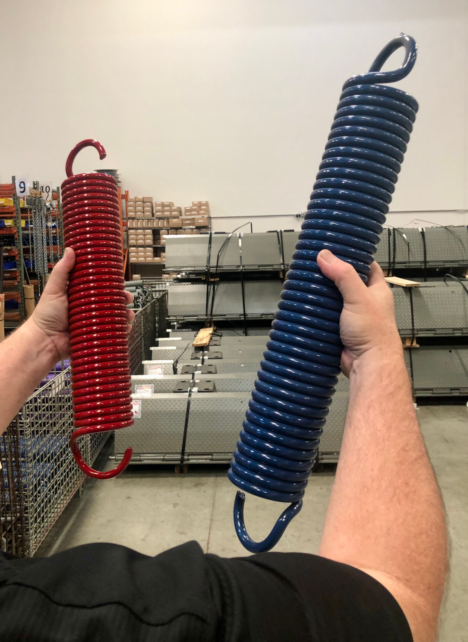 A person comparing two extension spring