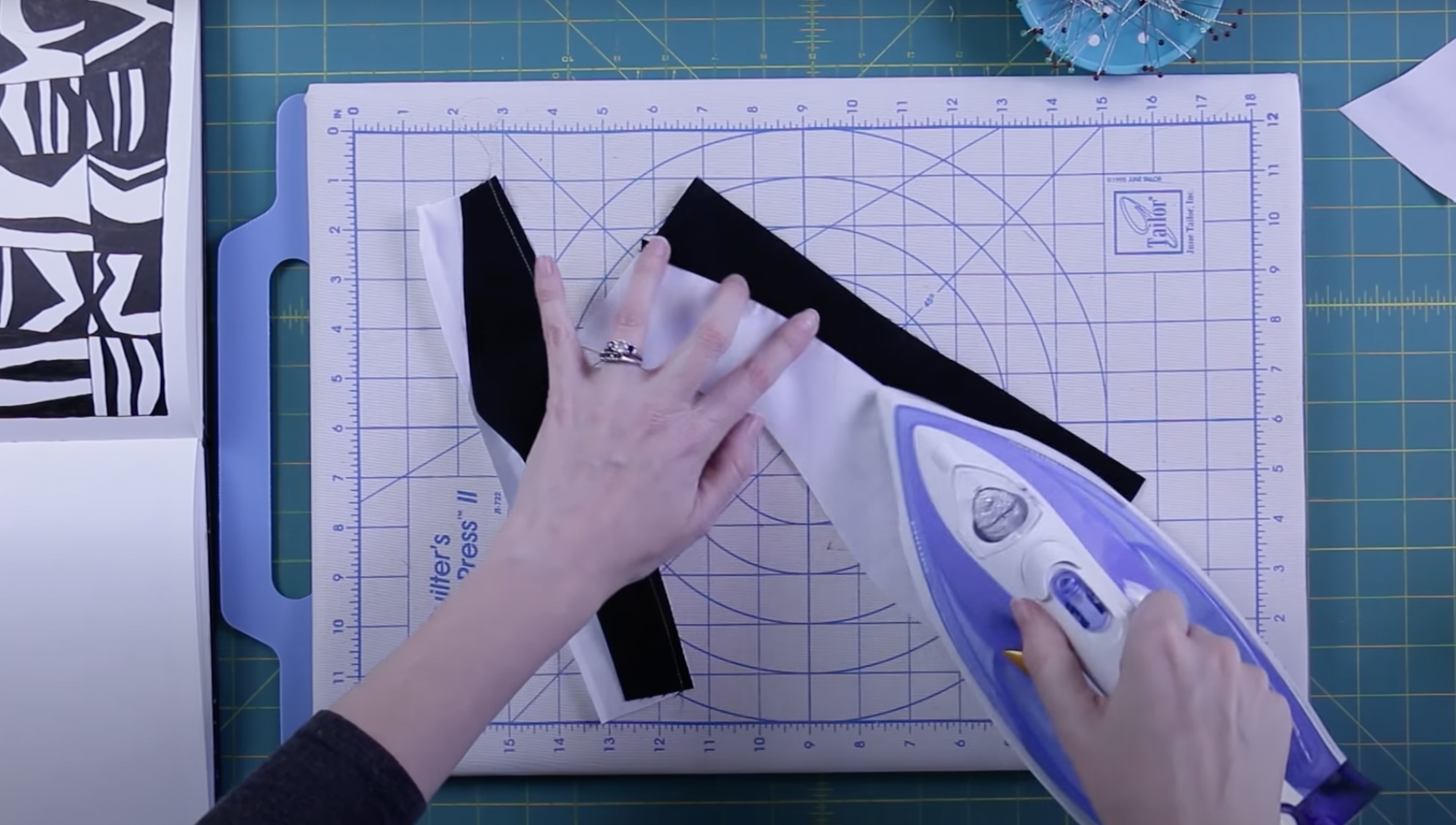 Image shows ironing improvisationally pieced curves