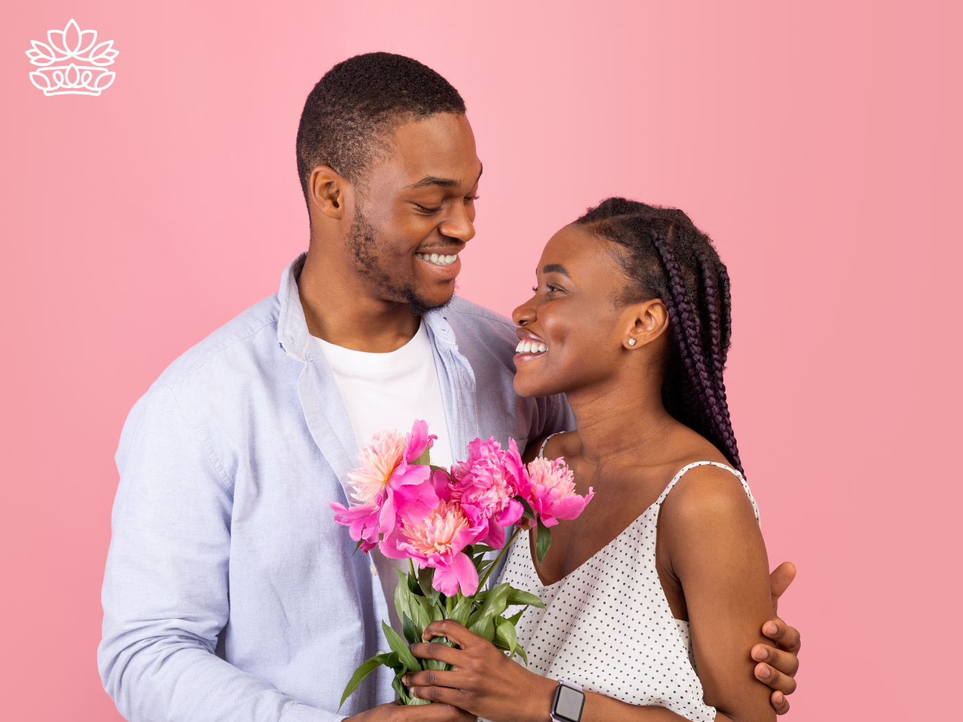 A couple exchanging a bouquet of pink flowers and smiling - Fabulous Flowers and Gifts, All Fabulous Flowers and Gift Boxes.