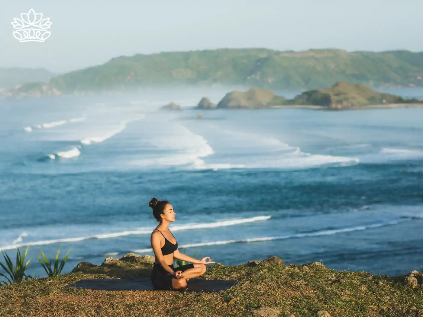 A woman practicing yoga by the sea, enjoying serenity and health benefits. Fabulous Flowers and Gifts - Health and Wellbeing Collection.