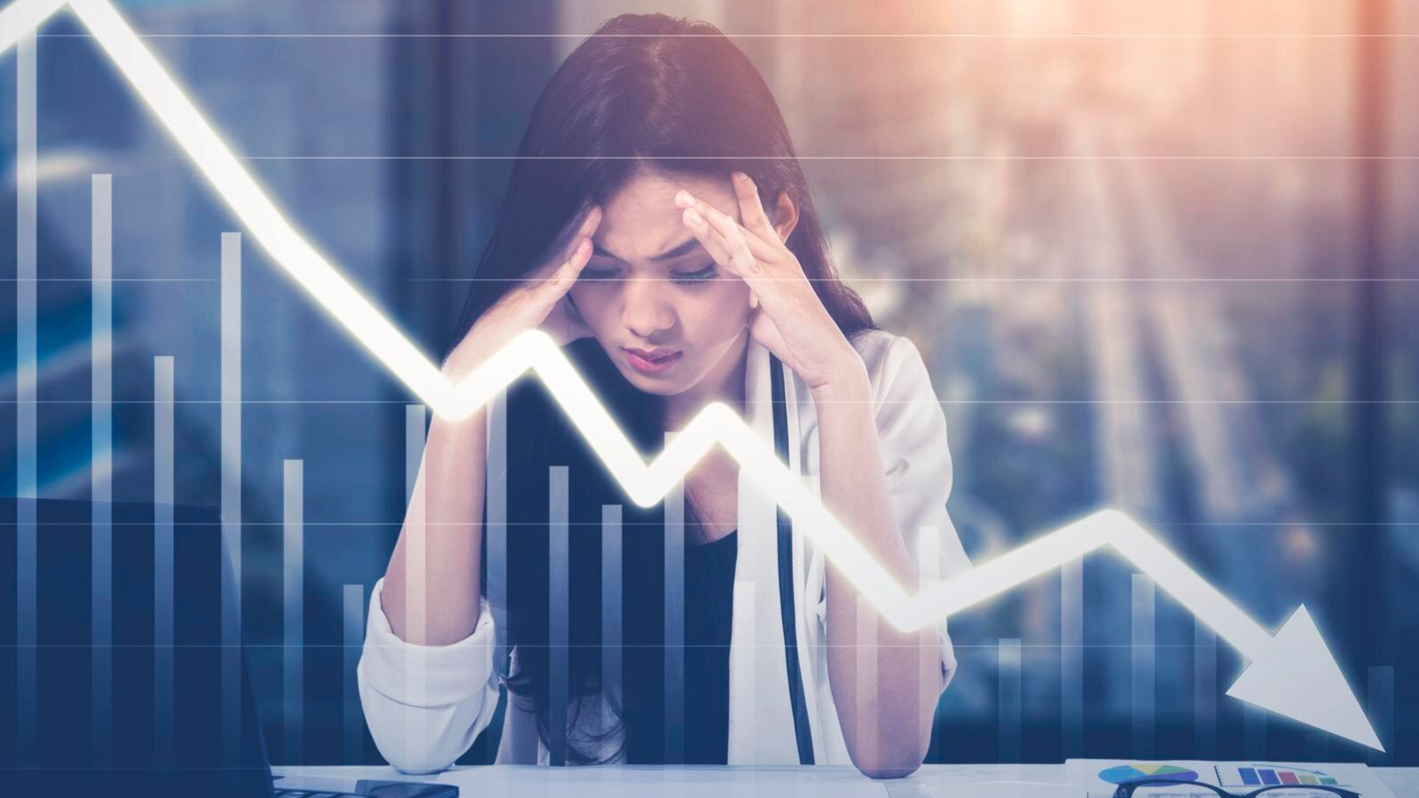 Woman stressed at desk as chart drops, reflecting how advertised speeds vary and poor internet in Austin TX affects small businesses.