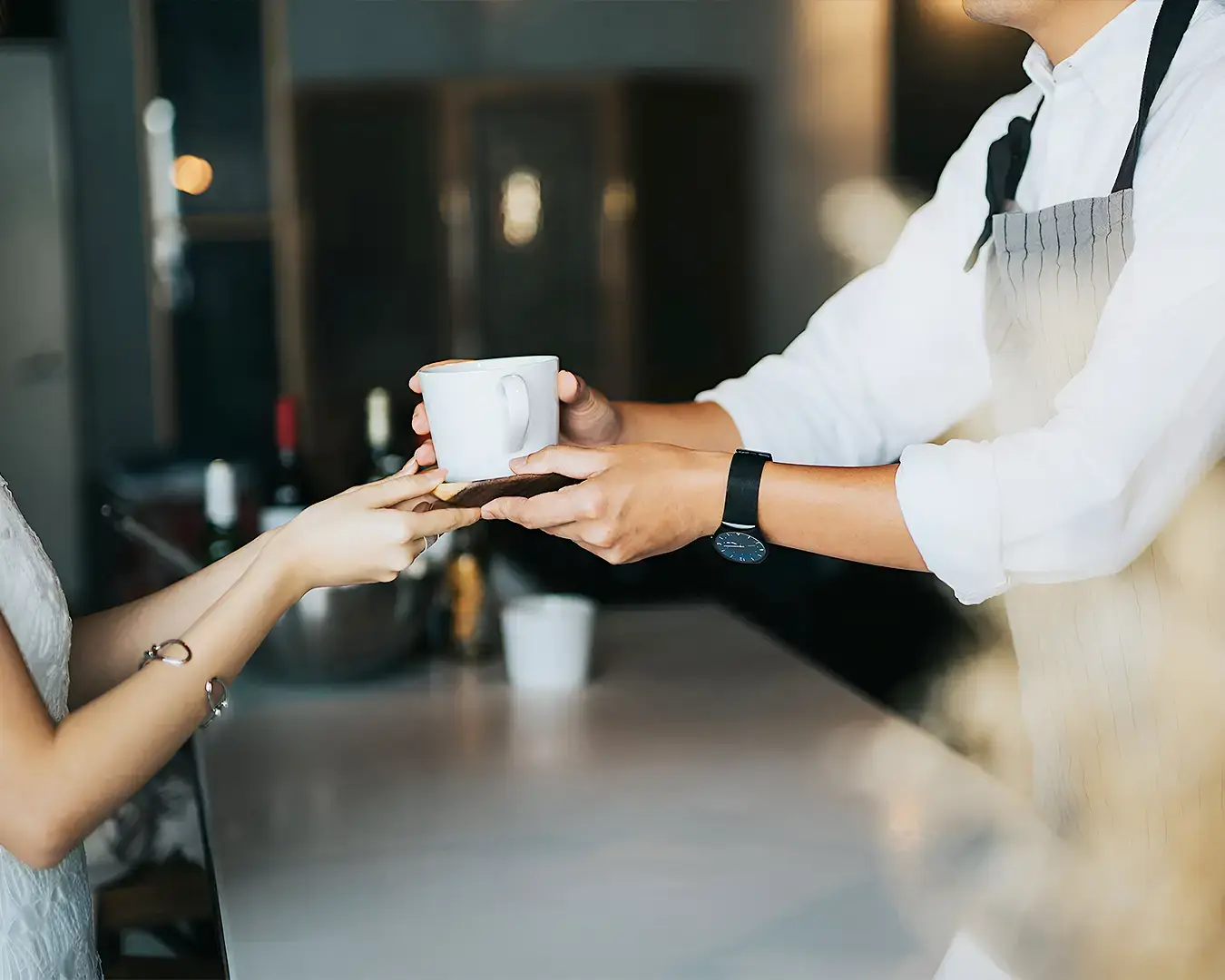 Restaurant server delivering coffee to customer, highlighting personalized hospitality and guest loyalty
