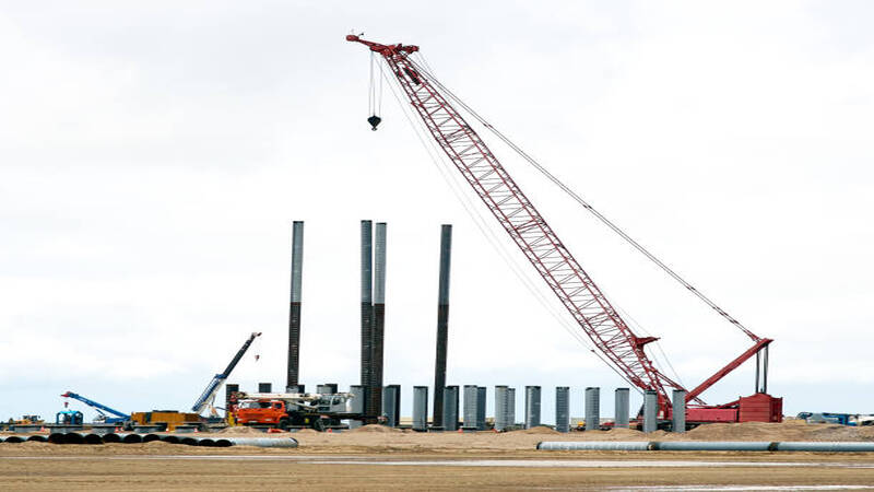 A pile driver installing piles