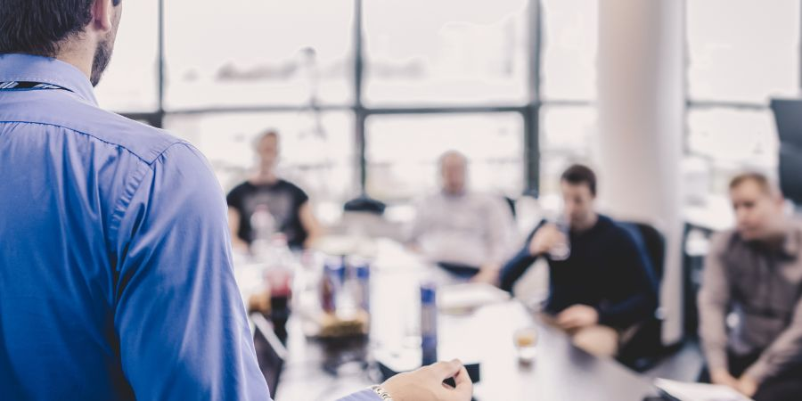 Business Continuity manager presenting to his team in a boardroom 