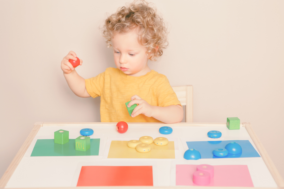 A young child playing with colorful toys