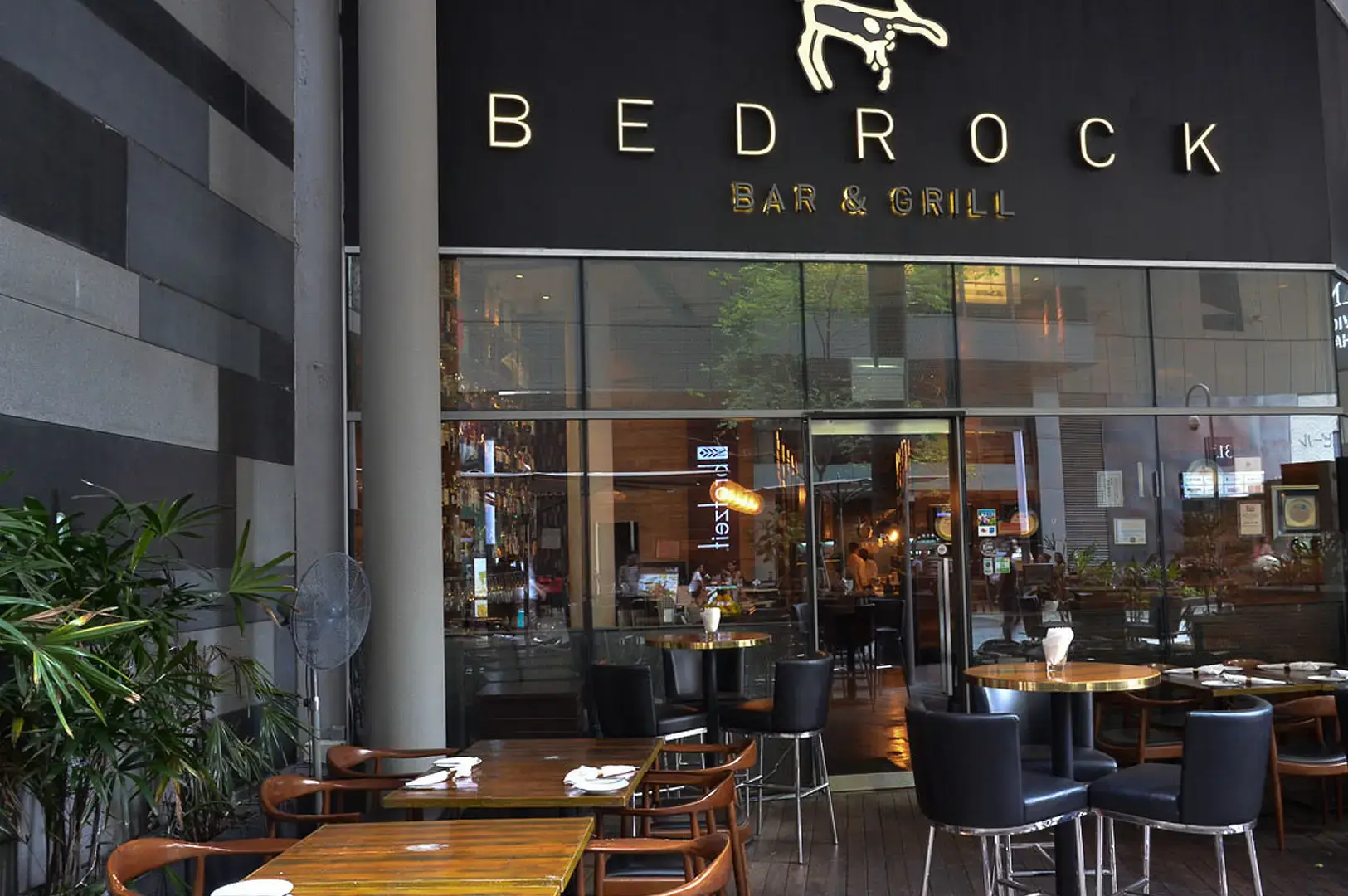 Bedrock Bar & Grill Singapore steakhouse exterior with outdoor dining tables and modern restaurant facade