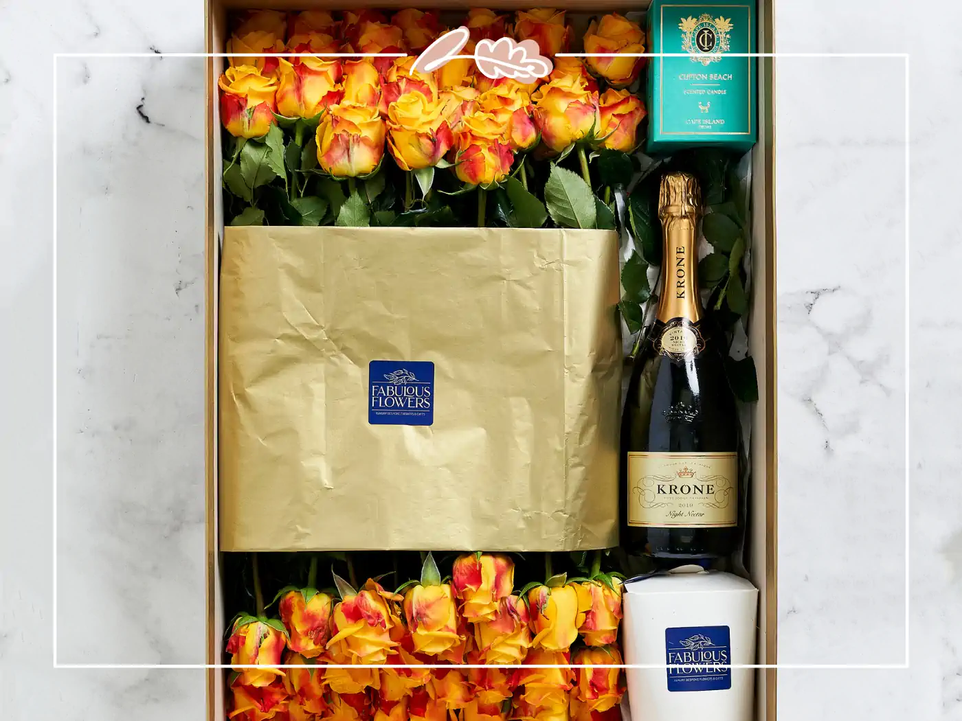 Box of yellow and orange roses with a bottle of Krone wine and a candle - fabulous flowers and gifts