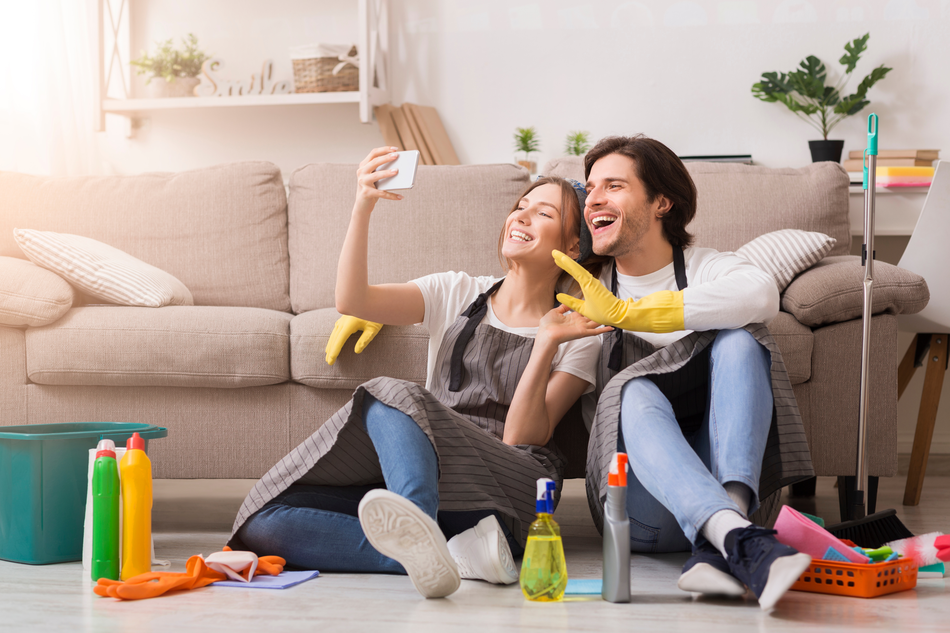 Photo by: AdobeStock/A happy couple after they finish cleaning their home.