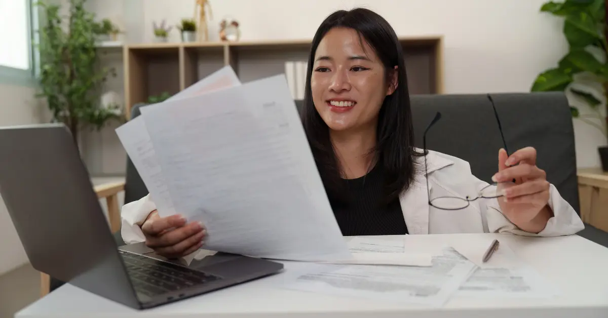 OnlyFans creator reviewing financial documents to determine reasonable salary for S Corp.