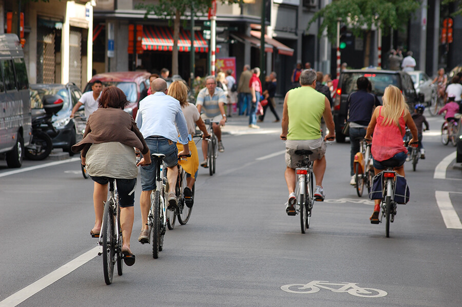 People being safe by following urban biking tips in bike friendly cities, cycle tracks, and other cities