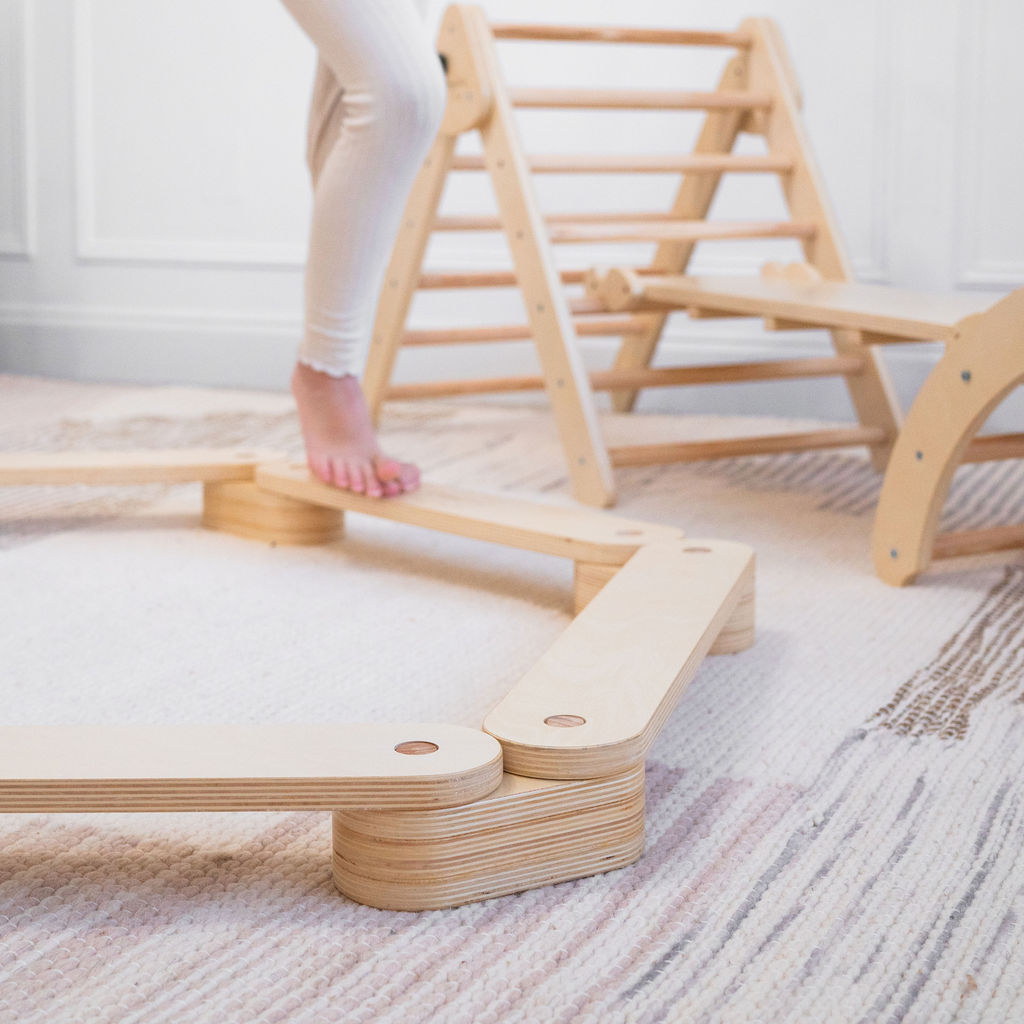 Children engaged in Montessori-inspired play with a balance beam