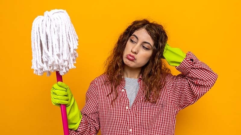 A woman looking at a mop head