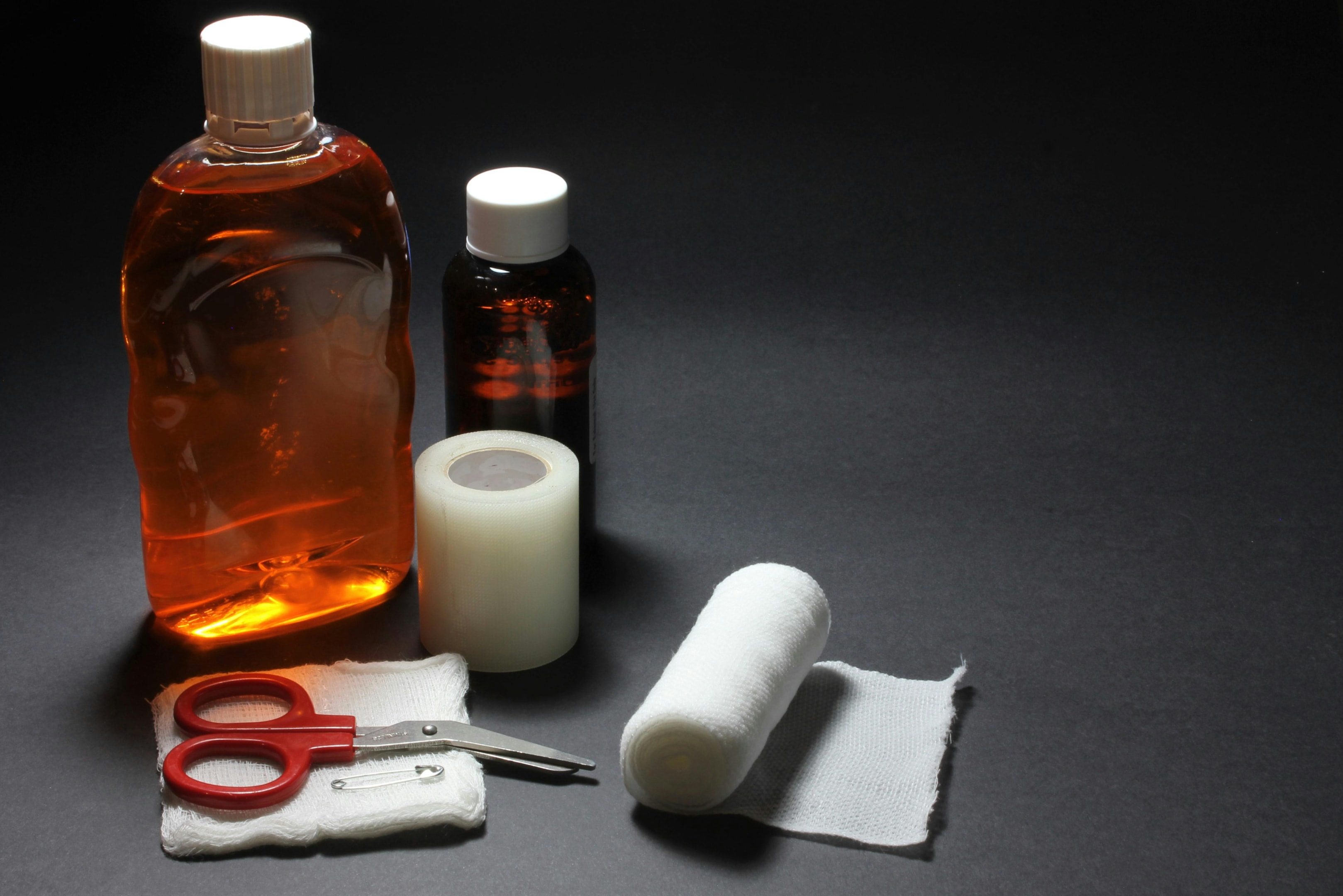 Antibacterial essentials including ointments, disinfectants, and gauze for infection prevention.