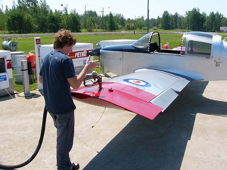 A Cessna 172 aircraft is parked next to an aviation fuel pump at an airport, ready for refueling with environmentally friendly aviation gasoline. This four-seat fixed-wing aircraft, known for its successful design and efficient fuel consumption, is a popular choice among aviation enthusiasts for training and leisure flying.