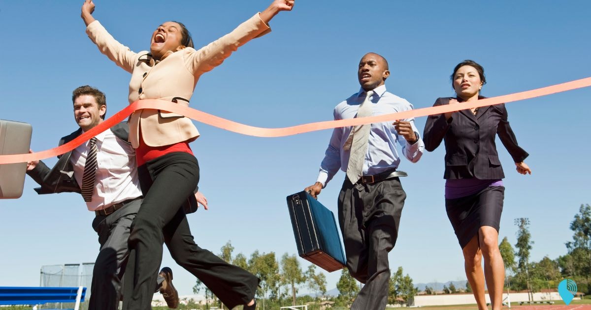 a team of company admins racing and crossing the finish line