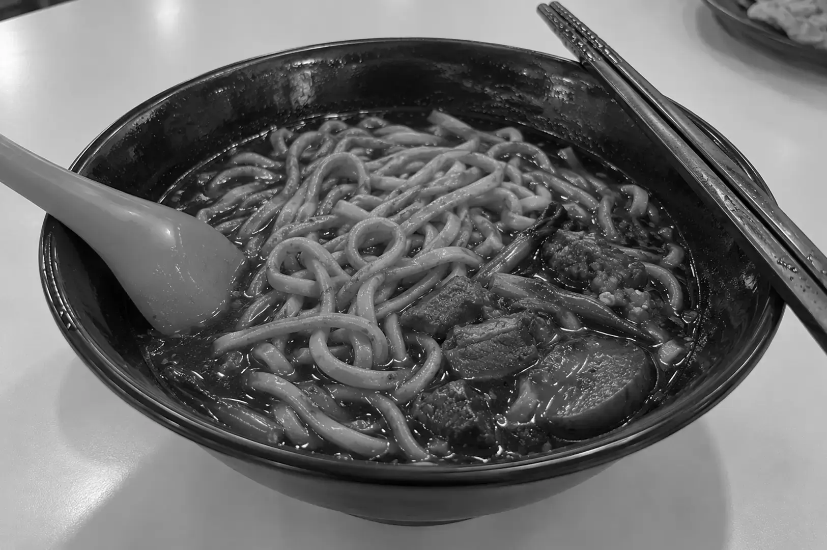 Thick noodles and braised toppings sit in a bowl of lor mee, known for its dark, starchy gravy.