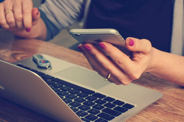 Image of a local business owner using a laptop to search for local businesses on a search engine