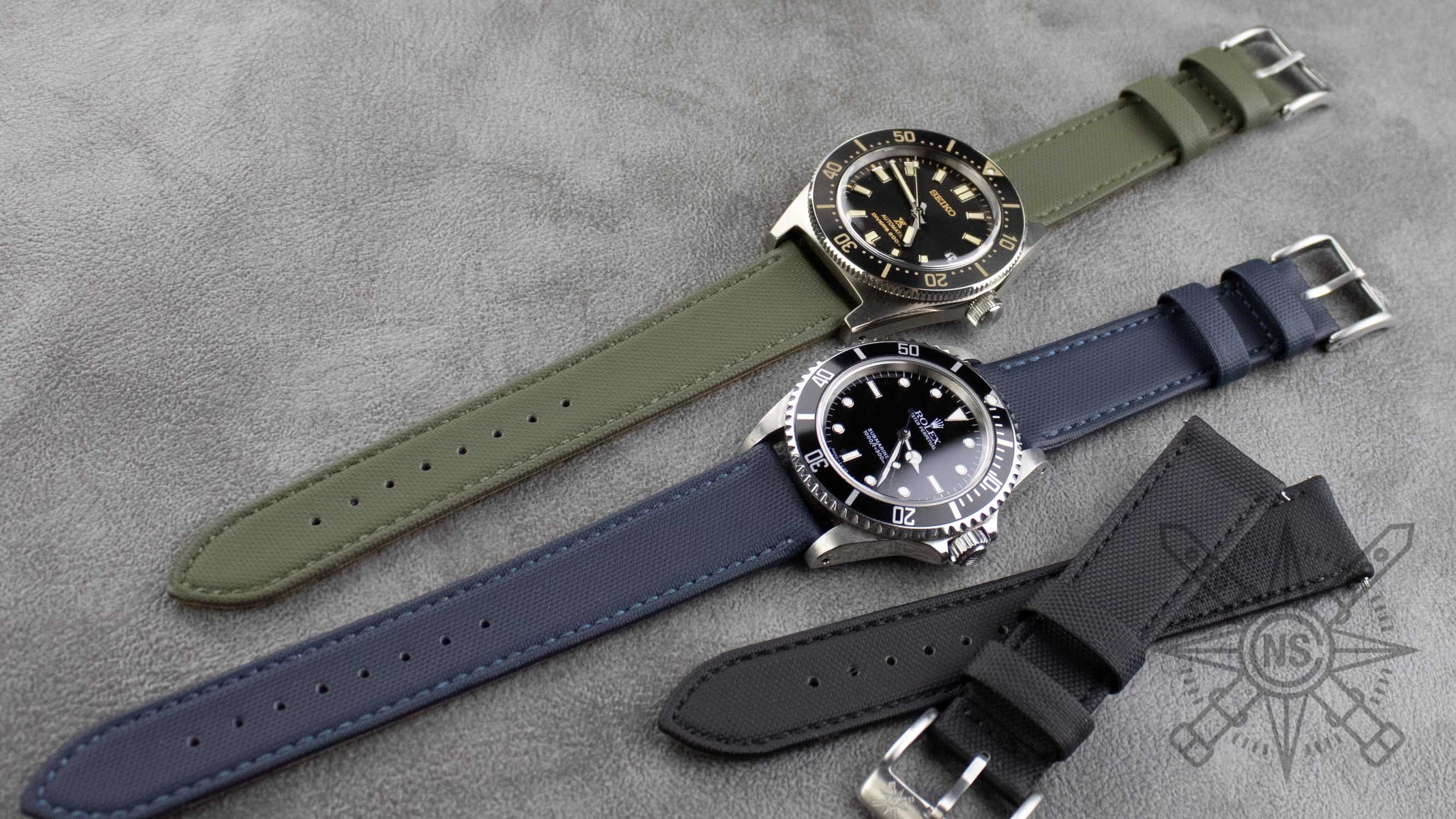 A collection of different colored sailcloth watch straps, including a blue sailcloth strap.