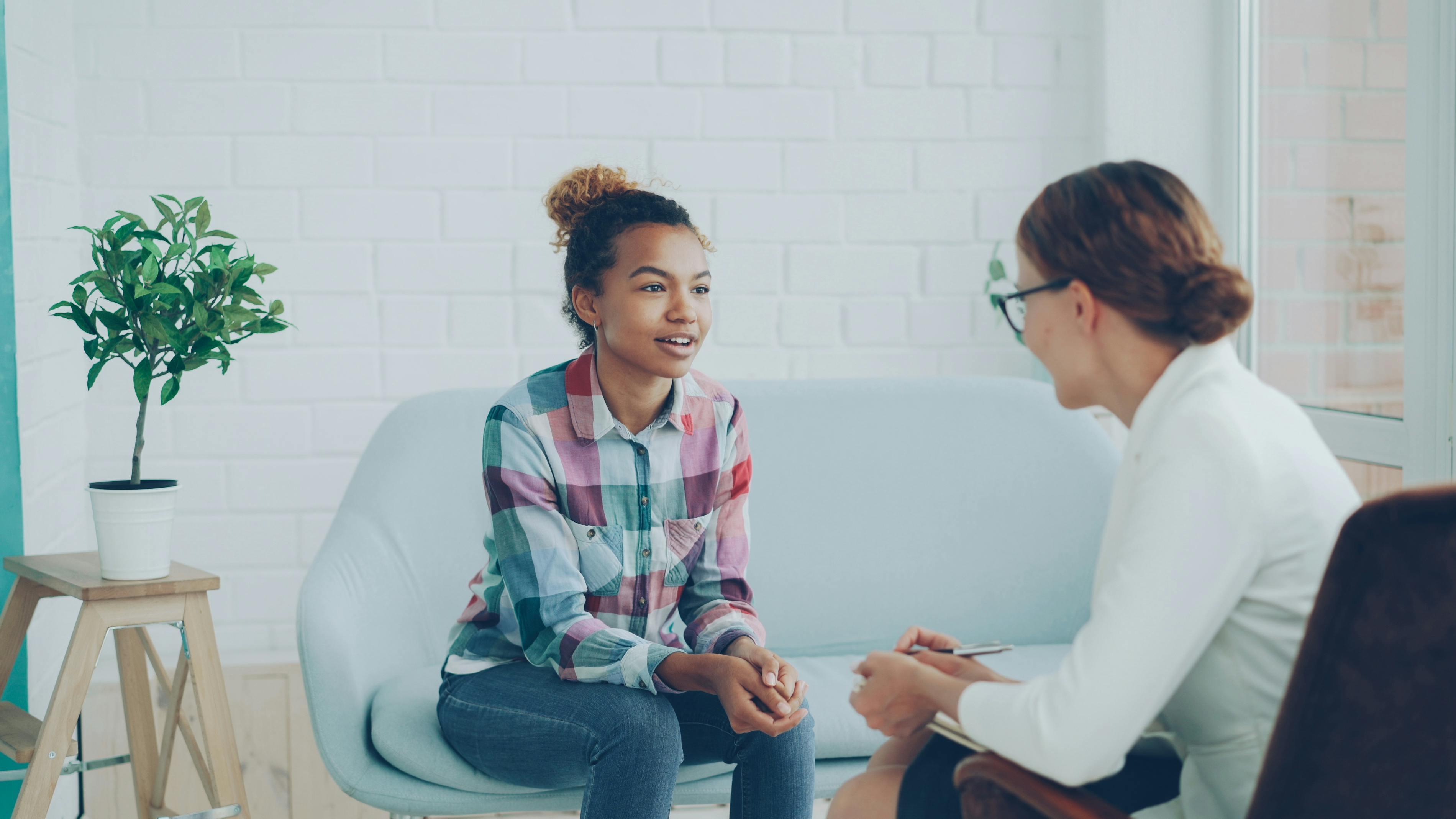 A young person speaks to a mental health professional about teen behavior issues