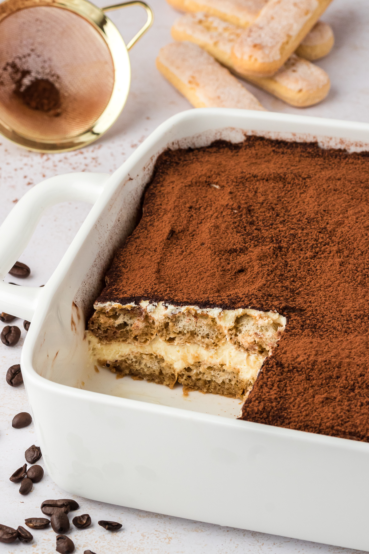 pan of tiramisu with slice taken out