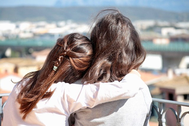 Two people hugging from a behind view.