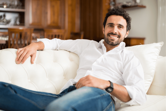 man relaxing after tooth extraction to ensure healthy healing
