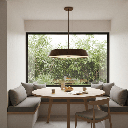 Wide drum pendant light hanging above a round dining table in a cozy breakfast nook with natural light.