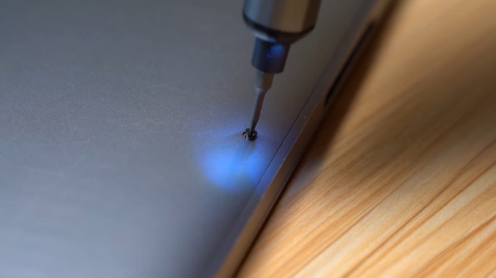 removing laptop screw using Jorest cordless screwdriver