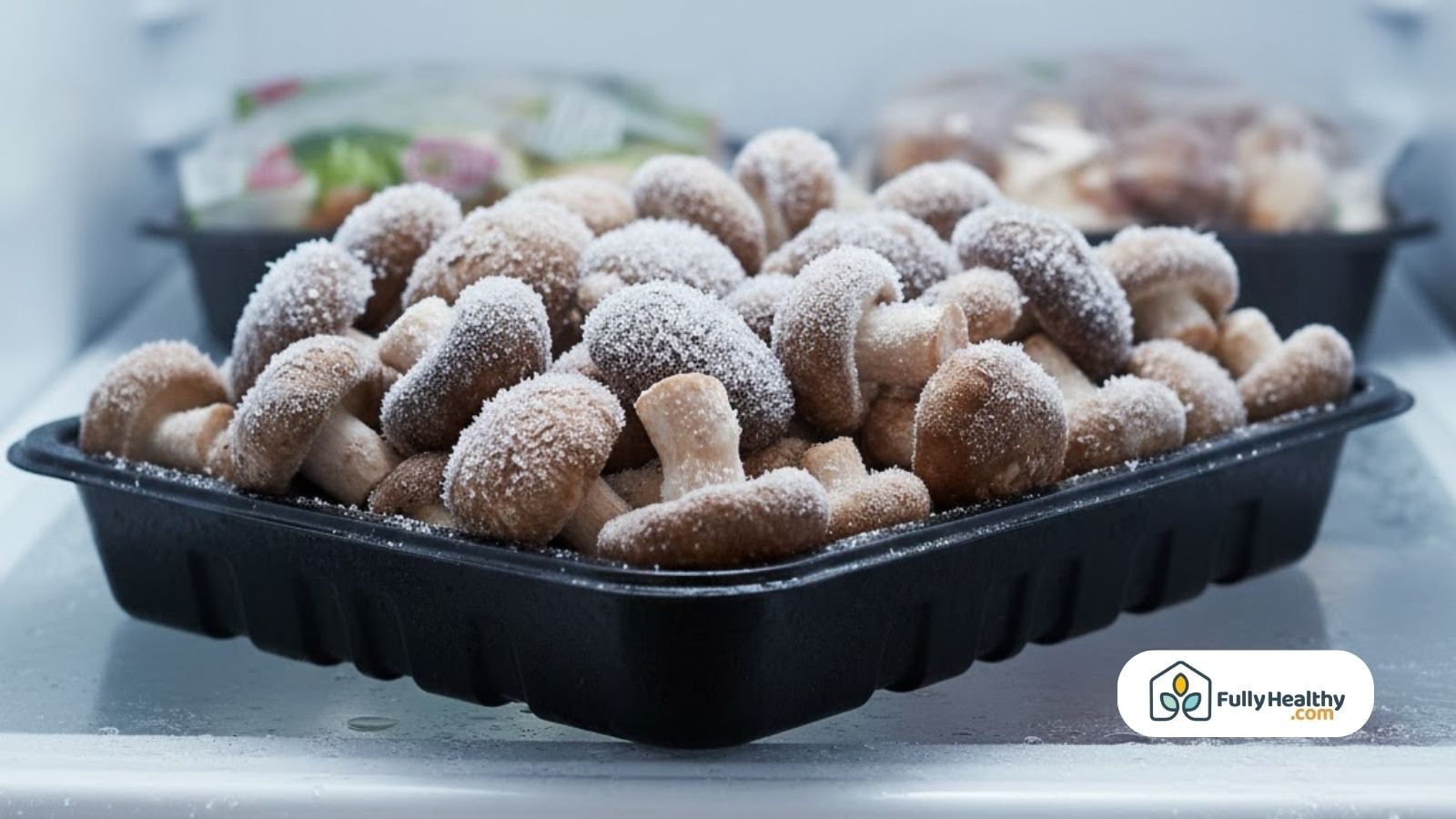 Frozen mushrooms in a black plastic tray stored inside the freezer.