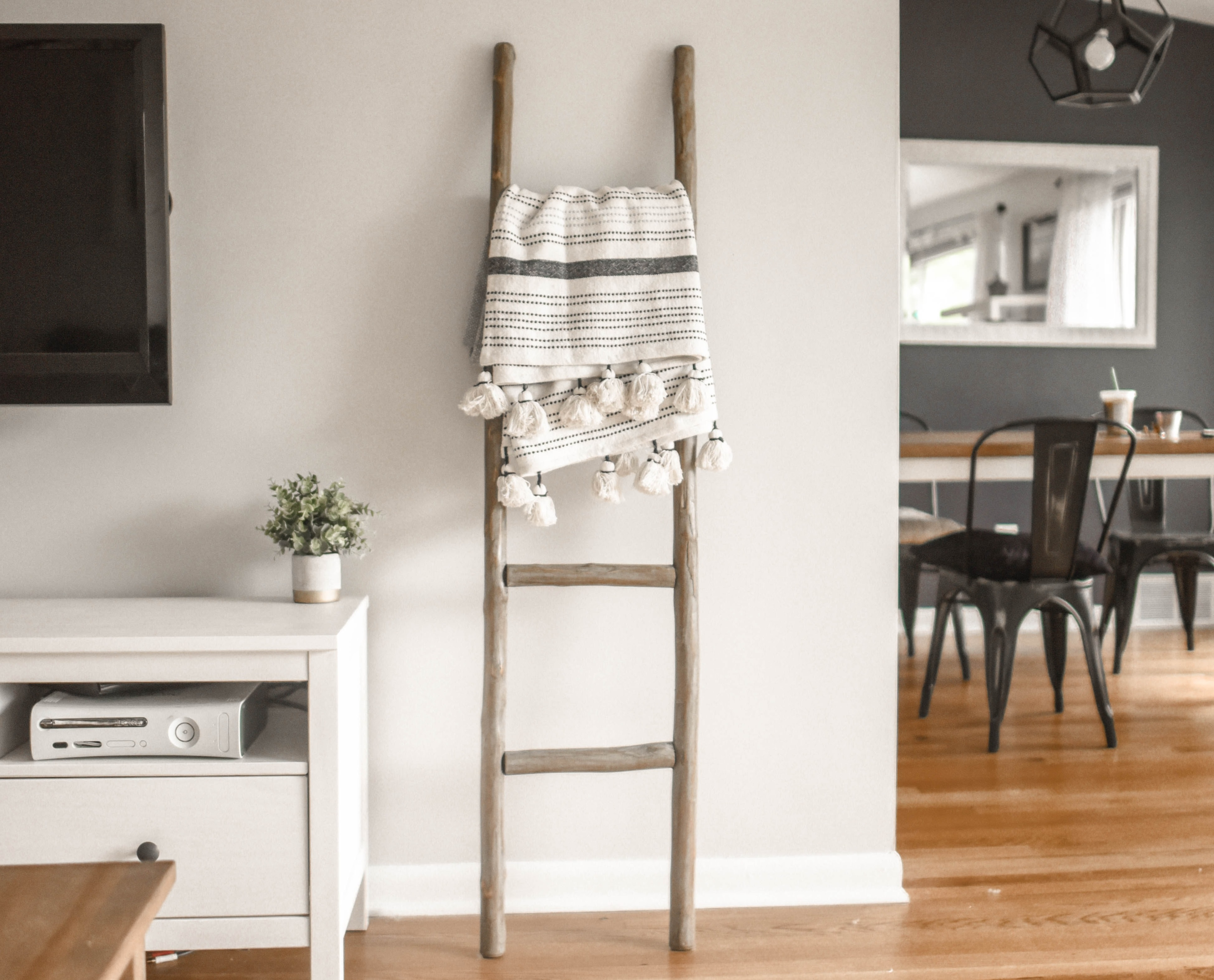 gray wooden decorative ladder on white wall