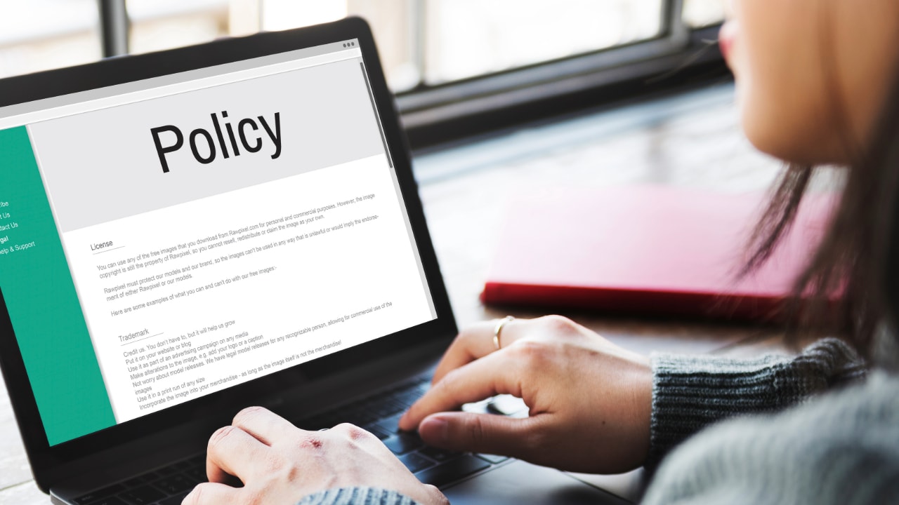 woman working on information security policy on laptop