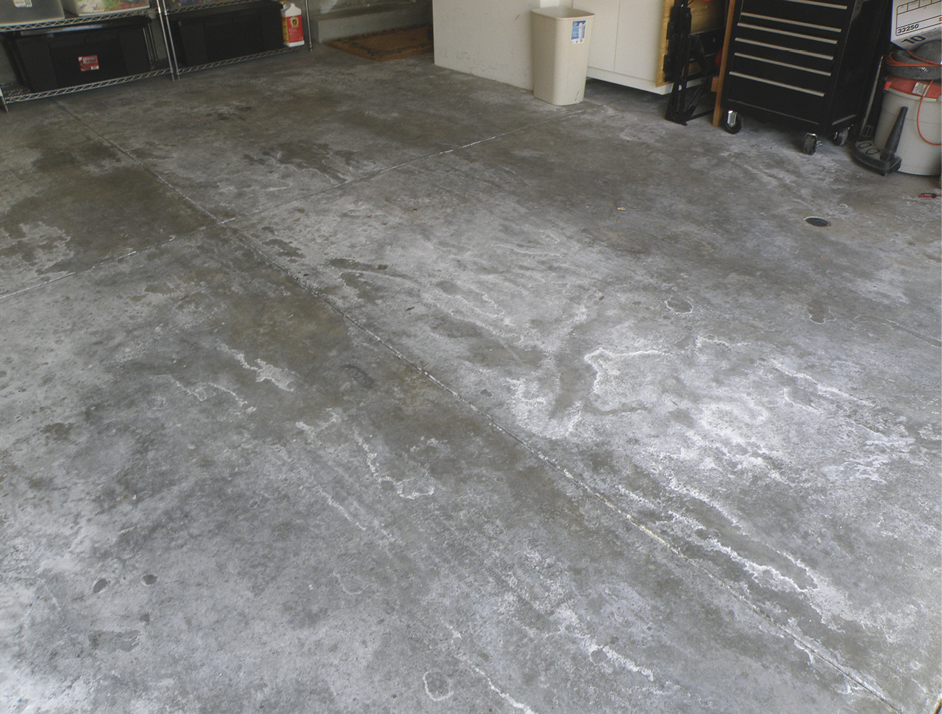 A picture of a concrete slab with visible signs of moisture problems
