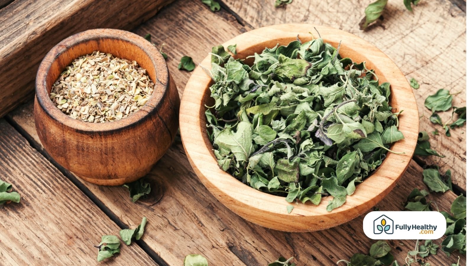 Dried oregano leaves and ground herb in rustic wooden bowls