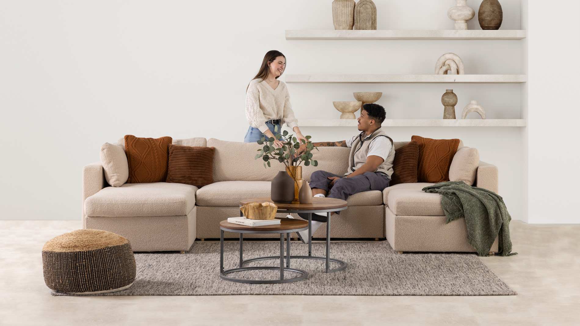 A couple taking to each other in a well lit modern living room