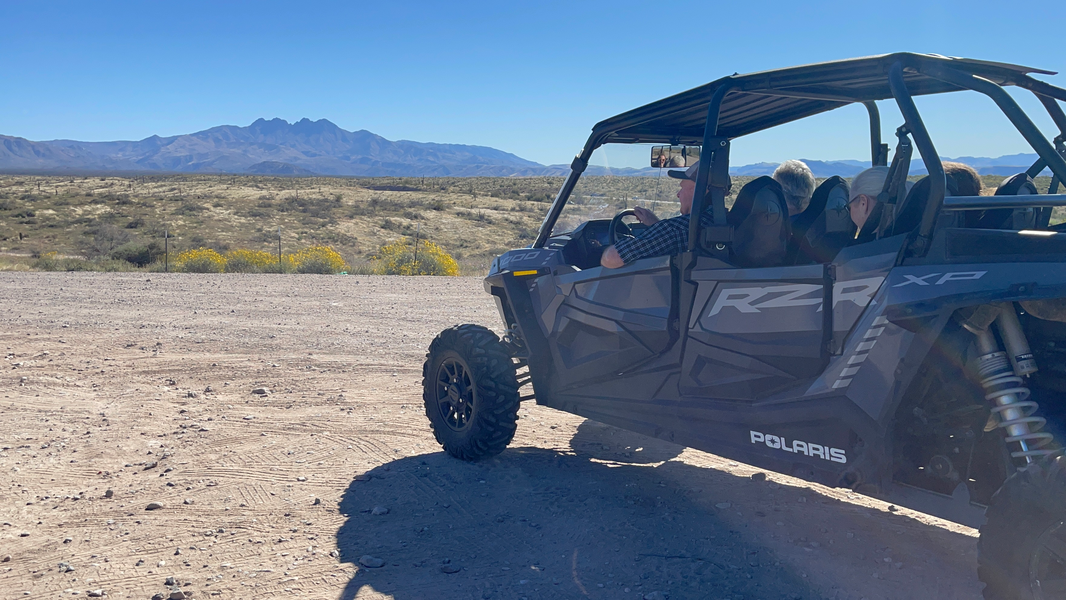 A group of people enjoying a guided UTV tour in the Arizona desert