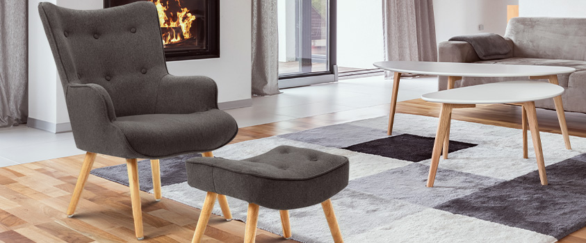 An Artiss Grey Accent Fabric Armchair Set, set in a living room with grey and white furniture and carpeting.