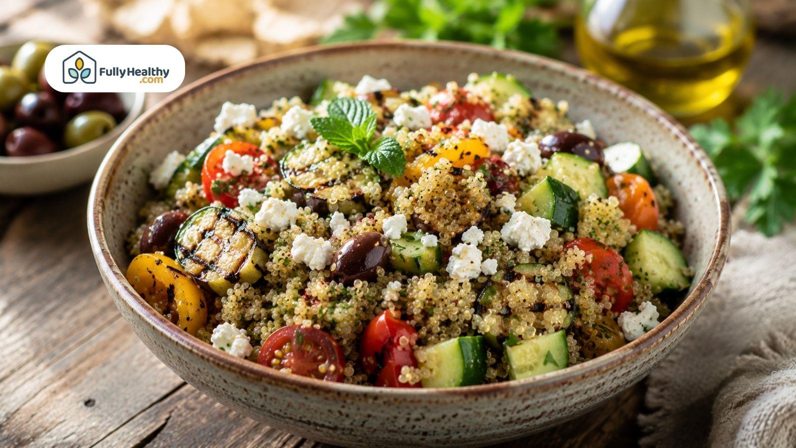 Mediterranean quinoa salad with grilled vegetables, feta, olives, and fresh herbs.