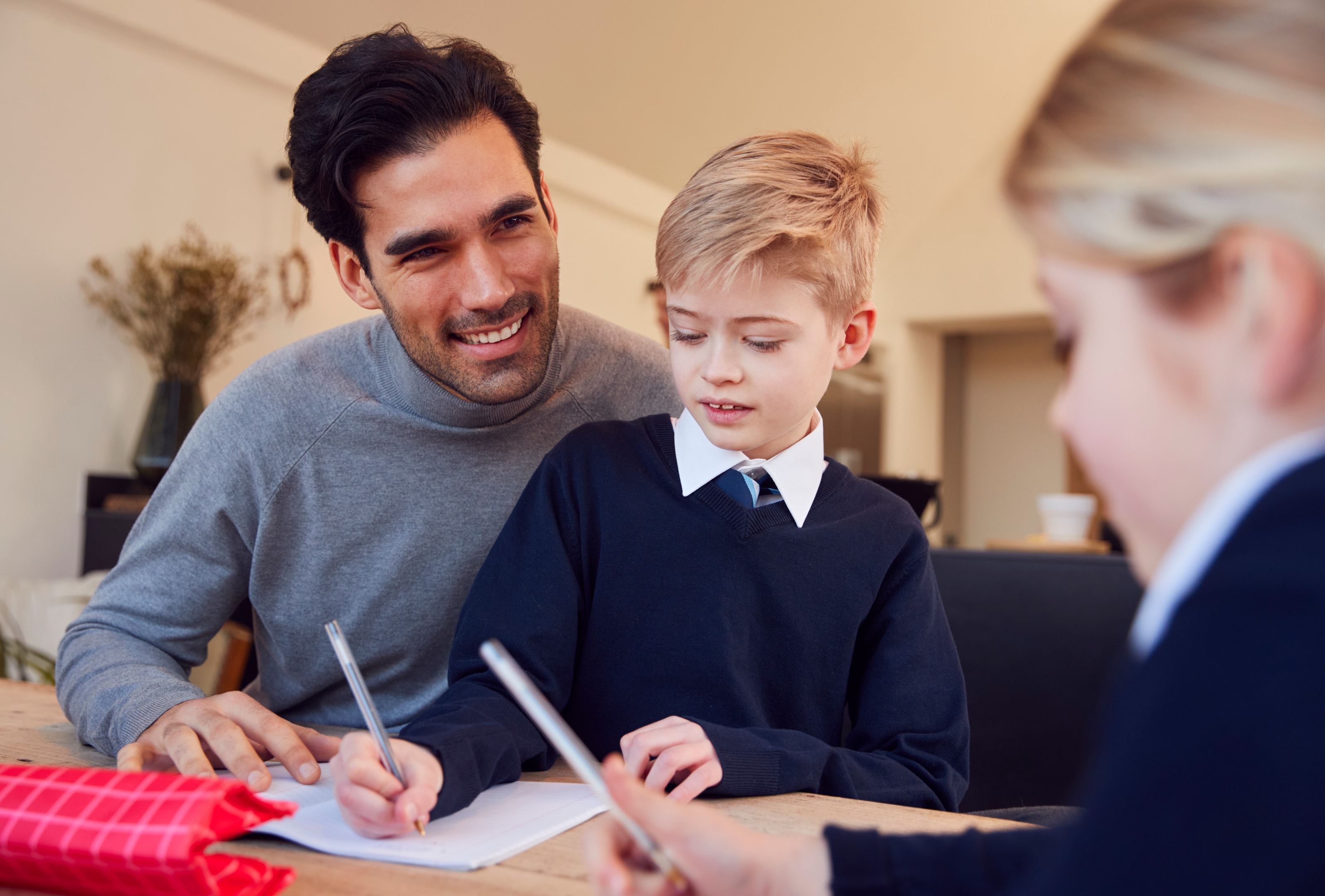 Father Helping Son And Daughter Wearing School Uniform