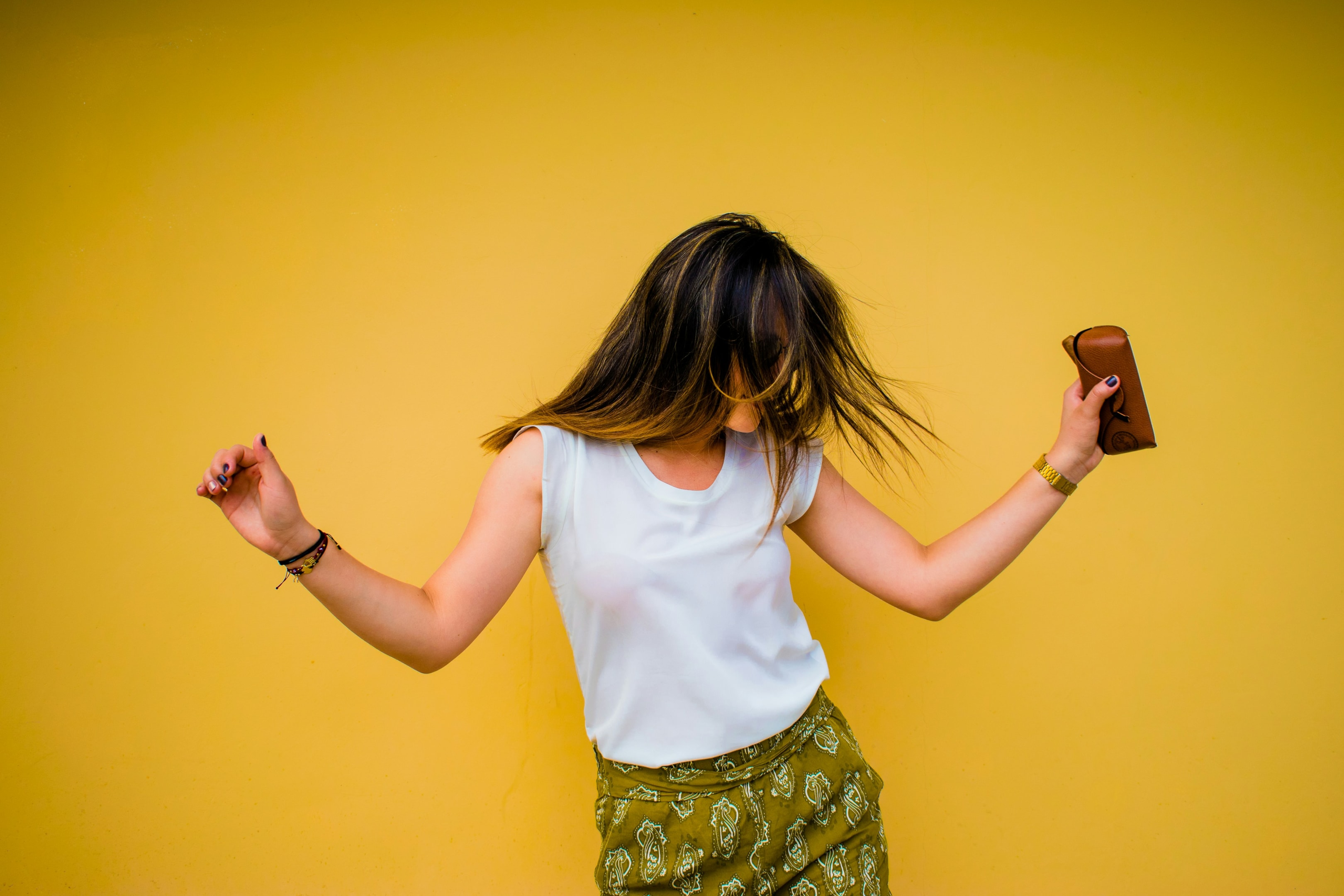 https://unsplash.com/photos/woman-standing-near-yellow-wall-maim4G7oRlo