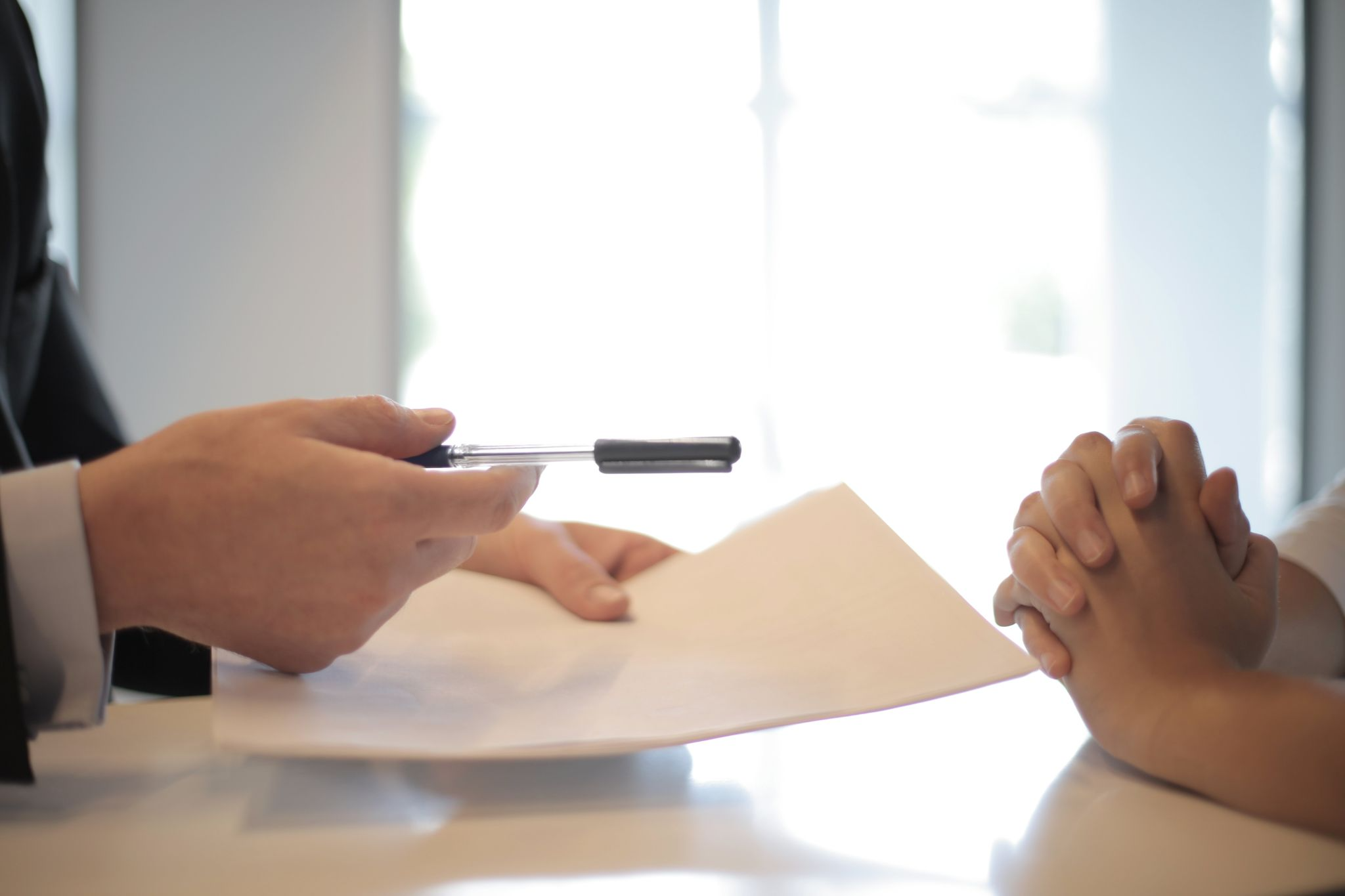 Handing a pen and form to another person