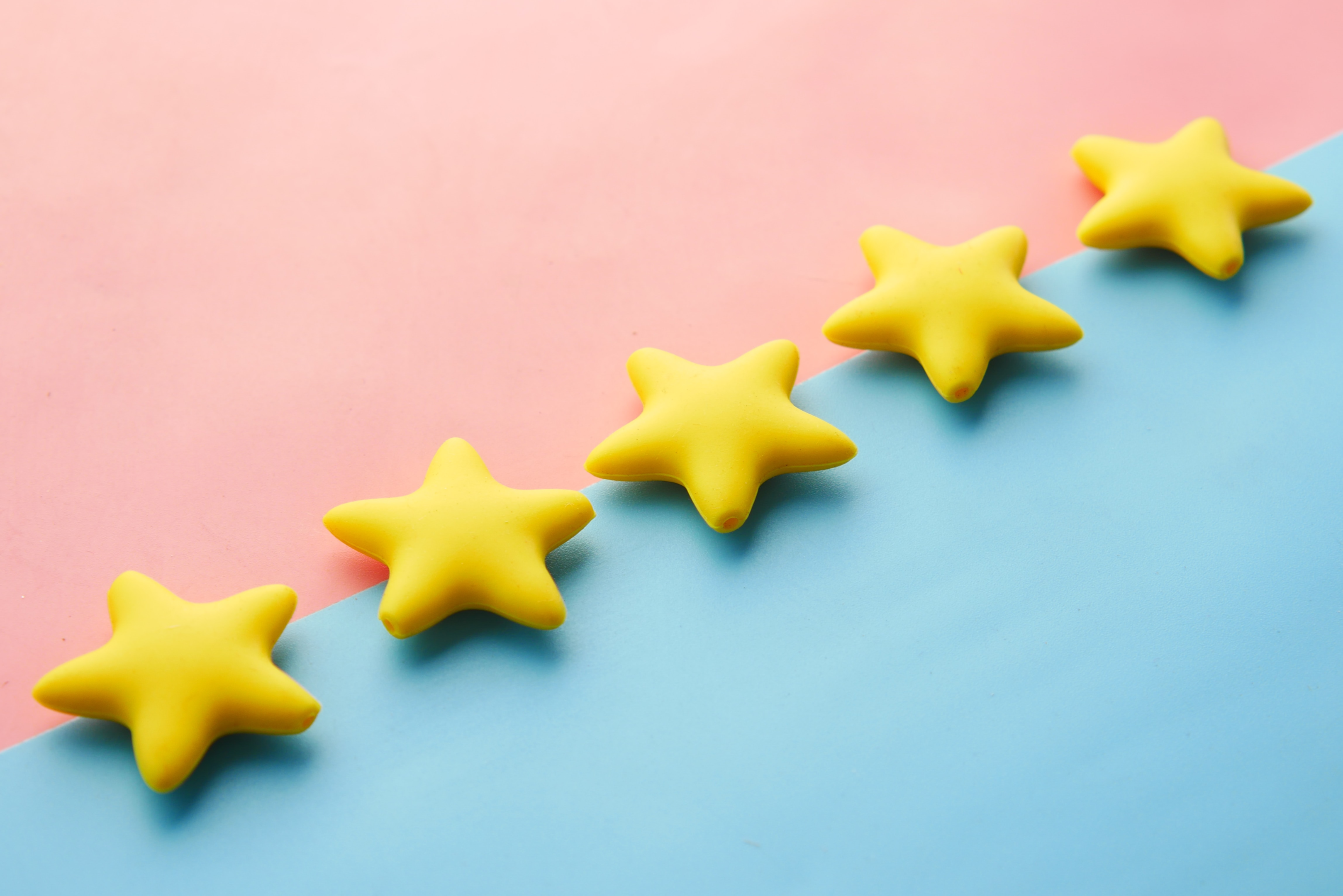 5 Cloth Stars lined up on a pink and blue background