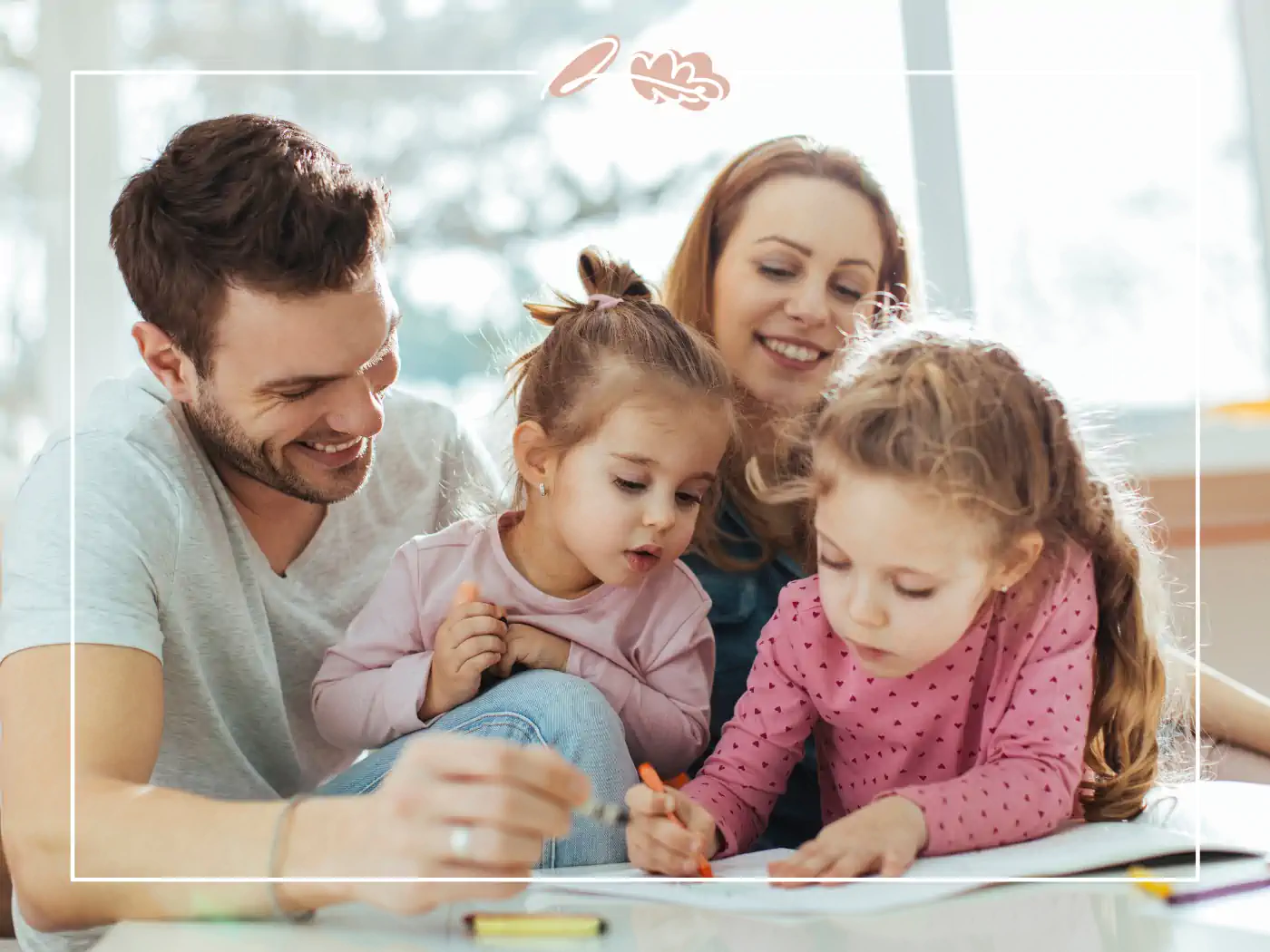 A family with two young daughters, all smiling and enjoying time together while drawing. Fabulous Flowers and Gifts.